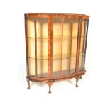 An early 20th Century circa 1930's Art Deco walnut bow front display cabinet having a single