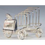 A contemporary silver plate toast rack in the form of a vintage motor vehicle. The racks of