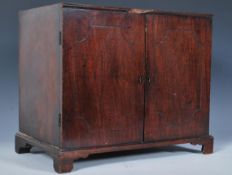 A 19th Century mahogany apprentice piece two door cabinet, the doors with carved detail to the