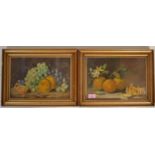 A pair of early 20th Century antique oil on canvas still life paintings, one depicting oranges on