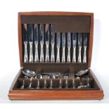 A cased canteen of cutlery by Ashberry France consisting of knifes and forks (various sizes),
