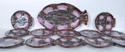 A set of twelve retro 20th Century pottery French oyster plates in the form of fish. Each plate