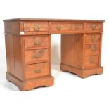 A Victorian 19th century pitch pine twin pedestal desk with brass drop handles and quatrefoil