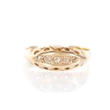 An early 20th Century stamped 18ct gold ring set with five round cut white stones to the head with