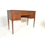 An early 20th Century mahogany desk having squared tapering legs with brass castors , the desktop