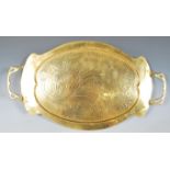 An Arts & Crafts oval copper twin handled copper tray in the manner of Joseph Sankey & Sons, with