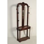 A 19th Century mahogany hall / hat stand having a twin arched back with turned knob hat rests with