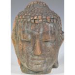 An early 20th Century South East Asian terracotta buddha head ornament having a dark patina to the