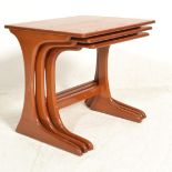 A nest of three vintage retro 20th Century Danish influenced teak wood nest of tables raised on