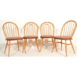 A set of four mid 20th century Ercol Windsor Quaker hoop-back dining chairs in light elm and beech