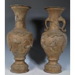 A pair of Japanese twin handled bronzed vases, probably Meiji period (1868-1912), with trumpet neck,