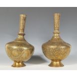 A pair of antique Anglo - Indian brass vases having bulbous bodies, with tapering tubular necks