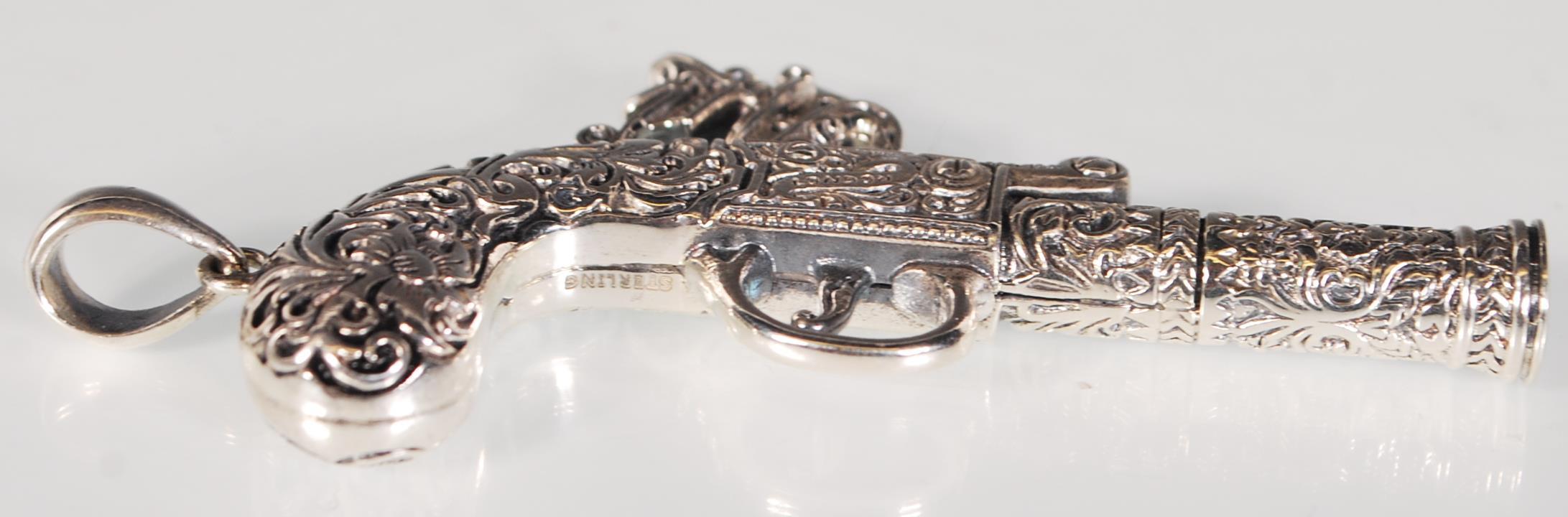 An unusual silver pendant whistle in the form of a flintlock pistol having finely engraved foliate - Image 3 of 5
