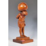 A 20th Century wooden carved oak lamp base in the form of a figure of Atlas raised on a square