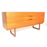 A retro mid 20th Century teak sideboard having a central bank of three drawers with inverted handles