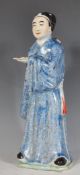 A 20th Century Chinese figure in the form of a scholar having a blue glazed robes with black