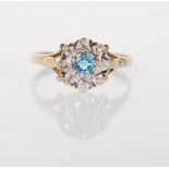 An English hallmarked 9ct yellow gold ladies dress ring ring set with a central round cut blue stone