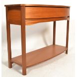 A retro 20th centurty style teak side table of demi-lune form having two vacuum drawers above a