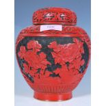 A 20th Century Chinese red cinnabar ginger jar of tapering bulbous form having a black ground