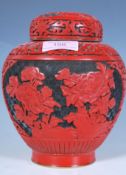 A 20th Century Chinese red cinnabar ginger jar of tapering bulbous form having a black ground