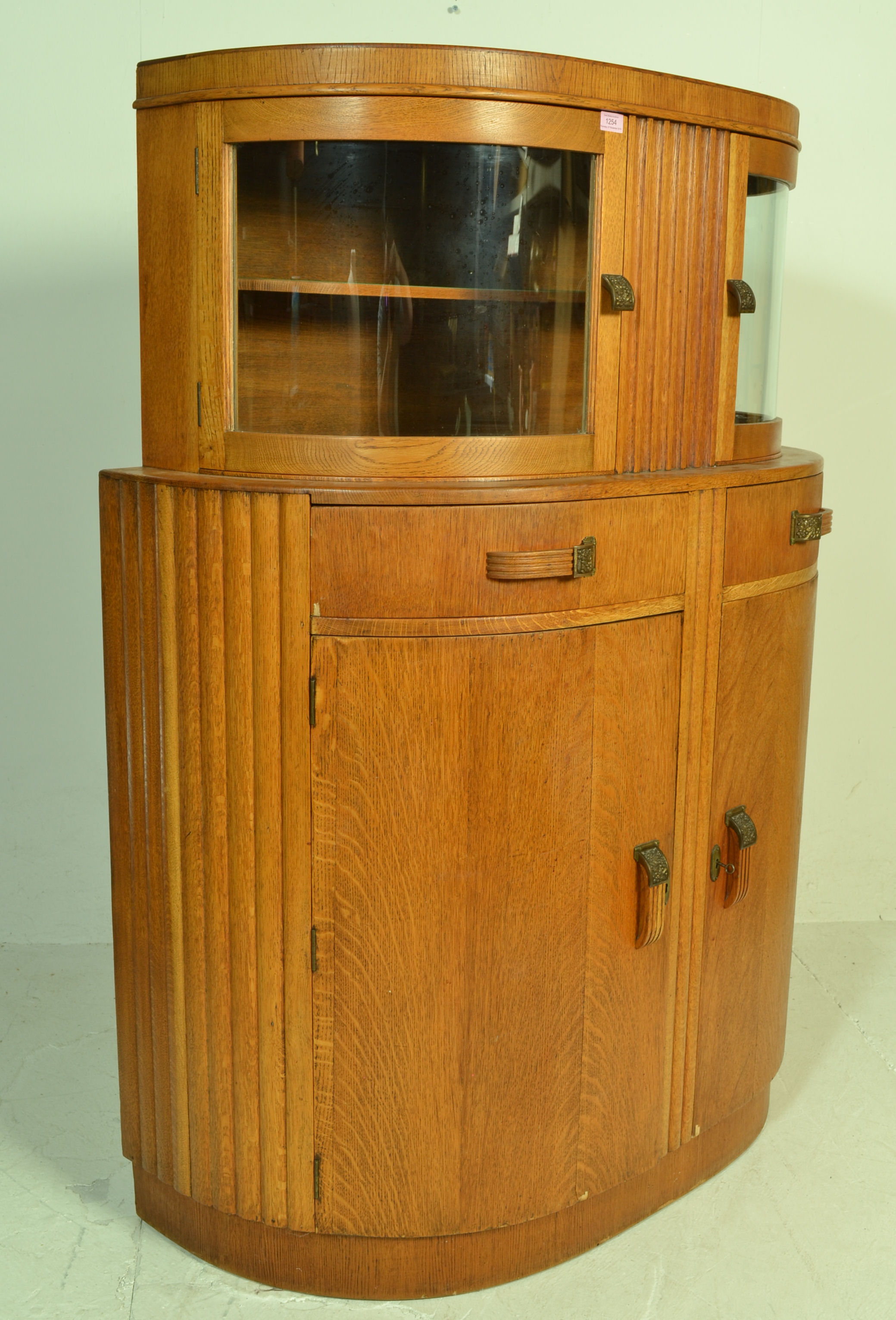 A 1930's Art Deco oak bow front sideboard / display cabinet. The twin bow front glass double door