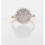 A stamped 375 9ct yellow gold diamond illusion set cluster ring having pierced decorated