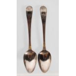 A pair of Georgian silver hallmarked tea spoons the handles being engraved with garland decoration