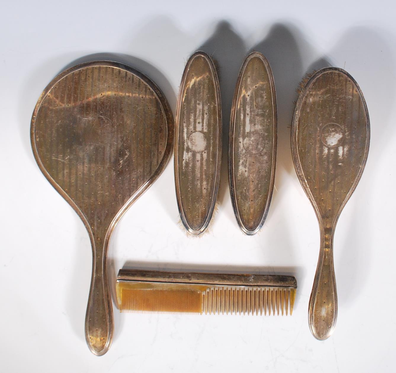 A six piece silver hallmarked ladies dressing table set, to include hand brushes, comb, hand