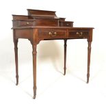 An 19th Century mahogany writing table / desk raised on ceramic castors with turned knopped legs,