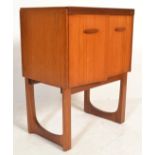 A vintage retro 20th Century teak wood music cabinet by Remploy having twin doors with shaped