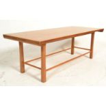 A mid century Danish inspired oak ' long john ' type coffee table. Raised on shaped legs united by