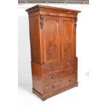 A Victorian 19th century mahogany linen press. Raised on a plinth base with short and deep drawer