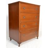A vintage mid 20th Century mahogany chest of drawers having a  central bank of four drawers having