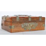 A 20th Century coromandel wood desk top box having brass mounts with scrolled pierced decoration and