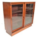 An early 20th Century mahogany display cabinet / shop fitting having twin glass fronted sliding