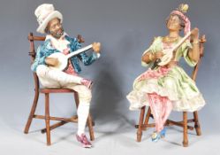 A pair of mid 20th Century ceramic continental creole band figures seated upon bamboo chairs playing