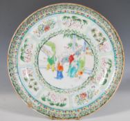 A 19th Century Chinese famille verte plate decorated with hand painted enamels, the central panel