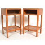 A pair of vintage retro 20th Century teak wood bedside tables raised on four block legs with lower