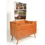 A retro mid 20th Century light oak dressing table chest having a central tapering mirror with two