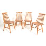 A set of four 20th Century vintage retro Ercol style spindle back dining chairs having shaped