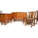 A 1930's Art Deco dining suite consisting of an oak sideboard having a central bank of four