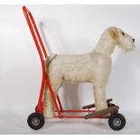A vintage 1950's  push / ride along Airedale terrier dog fixed to a tubular red painted metal