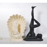 Two resin table lamps one in the form of a shell having a nude lady seated within the centre with