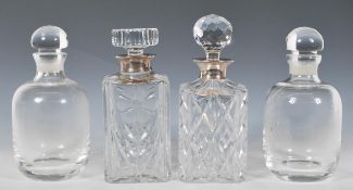 Two 20th Century cut glass decanters of square form, one being decorated with flowers with both