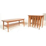 A retro 1970`s teak quartetto nest of tables, the large rectangular table raised on castors