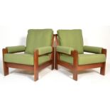 A pair of mid century teak wood easy armchair. Raised on teak show wood frames having upright