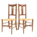 Two early 20th Century 1920's Art Deco oak framed liberty style bedroom / hall chairs having rush