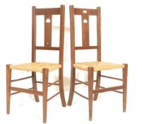 Two early 20th Century 1920's Art Deco oak framed liberty style bedroom / hall chairs having rush