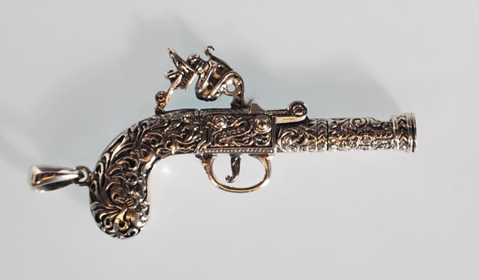 An unusual silver pendant whistle in the form of a flintlock pistol having finely engraved foliate - Image 2 of 5