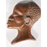 A 20th Century African bronze cameo wall plaque in the form of a male figure facing left, with